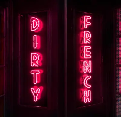 a red neon sign that says pizzeria at The Ludlow Hotel in New York
