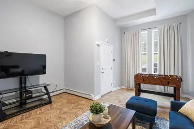 a living room with a flat screen tv and a couch at Cozy up with me! Longer stays! Free parking in Troy