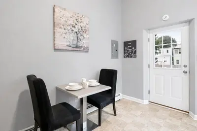 a dining room with a table and two chairs at Cozy up with me! Longer stays! Free parking in Troy