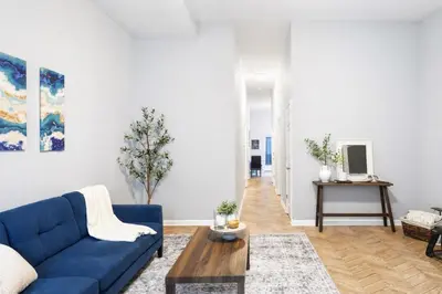 a living room with a blue couch and a table at Cozy up with me! Longer stays! Free parking in Troy