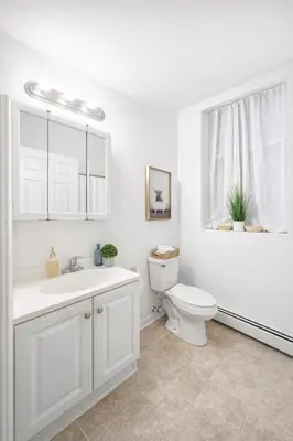 a white bathroom with a toilet and a sink at Escape your everyday in your COZY HIDEAWAY Feel right at home Relax recharge & unwind in Troy