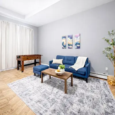 a living room with a blue couch and a table at Escape your everyday in your COZY HIDEAWAY Feel right at home Relax recharge & unwind in Troy