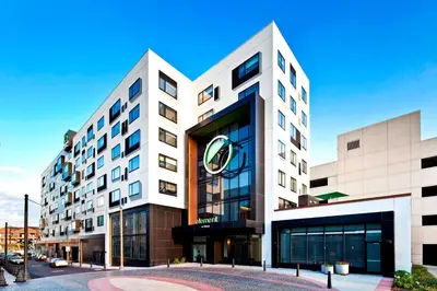 a large white building with a clock on it at Element Harrison-Newark in Harrison