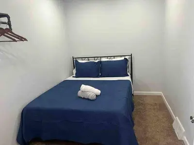 a bedroom with a bed with blue sheets and blue pillows at Two bedrooms with parking & washer/dryer in Schenectady