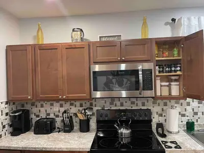 a kitchen with a stove and a microwave at Two bedrooms with parking & washer/dryer in Schenectady