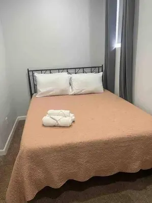 a bed with two towels on top of it at Two bedrooms with parking & washer/dryer in Schenectady