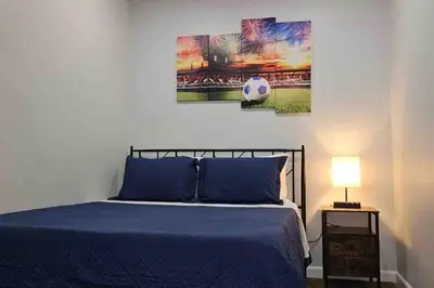a bedroom with a soccer ball painting on the wall at Two bedrooms with parking & washer/dryer in Schenectady