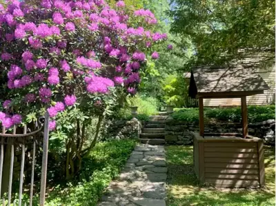 a garden with pink flowers and a wooden fence at INCREDIBLE Northern Westchester Historic Hideaway in South Salem