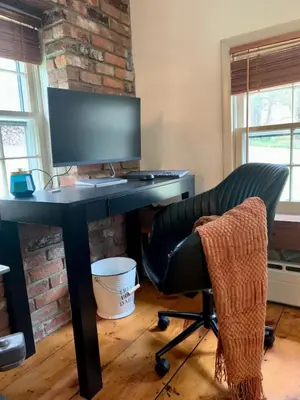 a computer desk with a monitor and a chair at INCREDIBLE Northern Westchester Historic Hideaway in South Salem