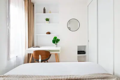 a white bedroom with a bed and a desk at 48-4FW Newly renovated W D Midtown in New York