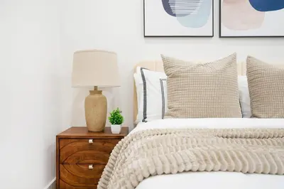 a bedroom with a bed and a lamp on a wooden nightstand at 48-4FW Newly renovated W D Midtown in New York