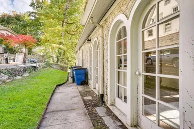 a sidewalk next to a building with a trash can at Walk to Harbor! Historic Mamaroneck Guest House in Mamaroneck