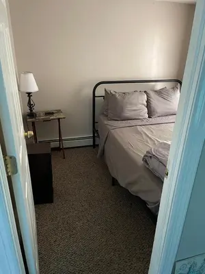 a bedroom with a bed and a table with a lamp at Mo Short Term Rentals in Mount Vernon