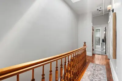 a staircase in a home with white walls at Newly Renovated 3BR Oasis Walk to Columbia Uni in New York