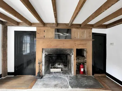 a living room with a fireplace in a house at Historic Estate - 5 min to Mohawk Mt Ski Resort in Cornwall
