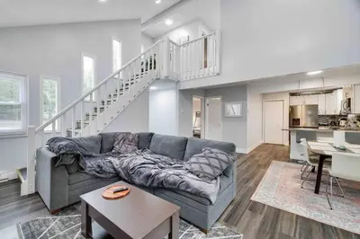 a living room with a couch and a staircase at Cozy, Spacious House *New*InTheCommunity+Fire Pit in Tobyhanna