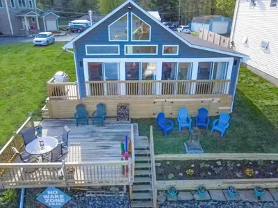 a house with a deck and chairs on it at Madison Cabin #2 in Hamilton