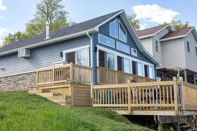a house with a large deck with a porch at Madison Cabin #2 in Hamilton