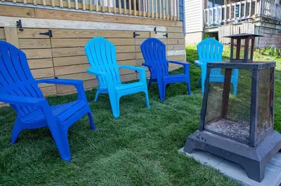 a group of blue chairs and a table in the grass at Madison Cabin #2 in Hamilton