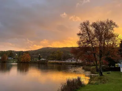 a view of a river with a sunset in the background at Lake View Retreat in Cambridge