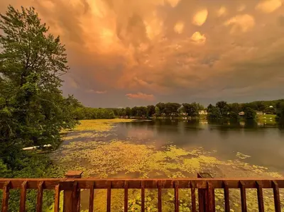 a view of a lake with a wooden fence at Lake View Retreat in Cambridge