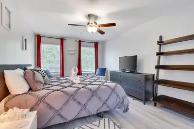 a bedroom with a bed and a ceiling fan at Nature’s Haven:4 br/2.5 bath, game room & Fire pit in Tobyhanna