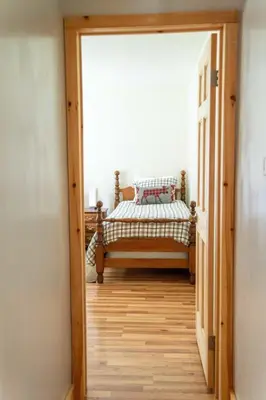 a hallway with a bed in a room at Cozy Cabin in Stratton Mountain & Mount Snow 10min in Stratton