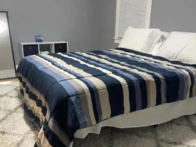 a bedroom with a bed with a blue and white blanket at Comfy 3 Bed 1 Bath with Wifi in College and Restaurant Area in Springfield