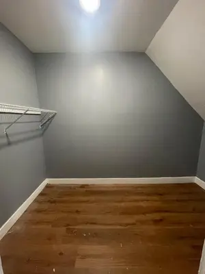 an empty room with a gray wall and wooden floors at Comfy 3 Bed 1 Bath with Wifi in College and Restaurant Area in Springfield