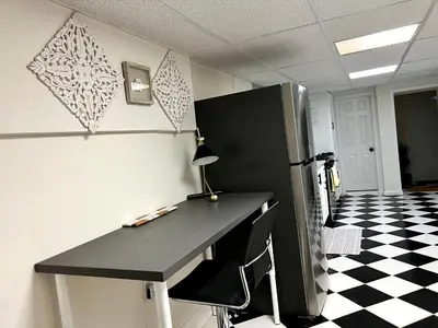 an office cubicle with a desk and a refrigerator at 6-A Diamond in Yonkers, NY in Yonkers