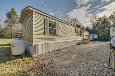 a house with a water tank in front of it at Northville Cabin with Fire Pit, 4 Mi to Boat Ramp! in Northville