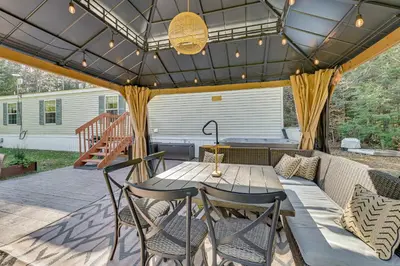 a patio with a table and chairs and a couch at Northville Cabin with Fire Pit, 4 Mi to Boat Ramp! in Northville