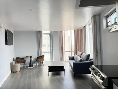 a living room with a couch and a table at Starlight Hotel Near LGA Airport in Queens