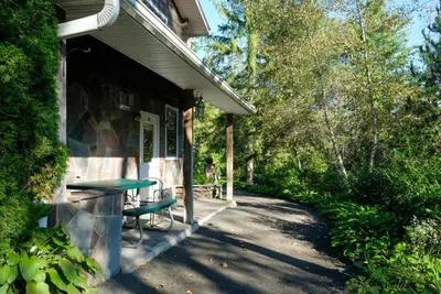 a porch of a house with a table and chairs at Belleayre Lodge in Pine Hill