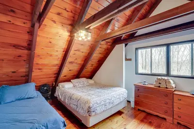 a bedroom with a bed and a dresser in a cabin at Hunter Mountain Home with Game Room 1 Mi to Skiing! in Hunter