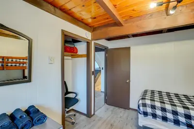 a bedroom with a bed and a mirror on the wall at Hunter Mountain Home with Game Room 1 Mi to Skiing! in Hunter