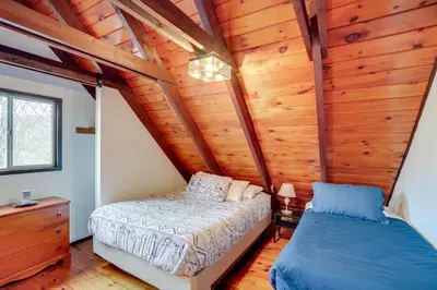 a bedroom with a bed and a wooden ceiling at Hunter Mountain Home with Game Room 1 Mi to Skiing! in Hunter
