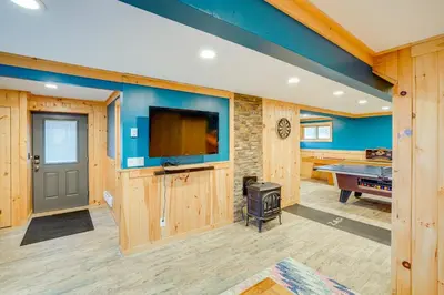 a living room with a tv and a pool table at Hunter Mountain Home with Game Room 1 Mi to Skiing! in Hunter
