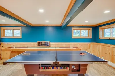 a ping pong table in a room with blue walls at Hunter Mountain Home with Game Room 1 Mi to Skiing! in Hunter