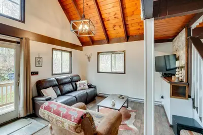 a living room with a couch and a tv at Hunter Mountain Home with Game Room 1 Mi to Skiing! in Hunter