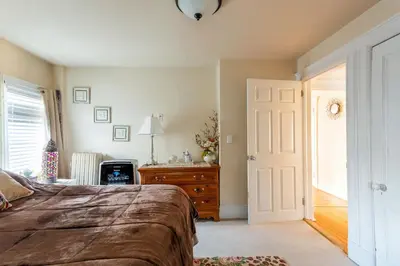 a bedroom with a bed and a dresser and a door at Sunny & Spacious Montclair NJ Apartment in Montclair