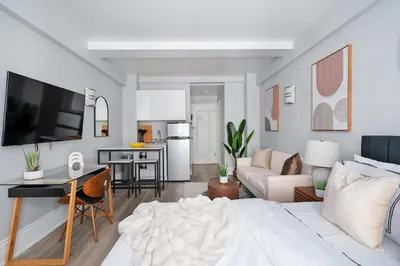 a living room with a bed and a kitchen at 73-1204 New Studio UWS Doorman Gym in New York