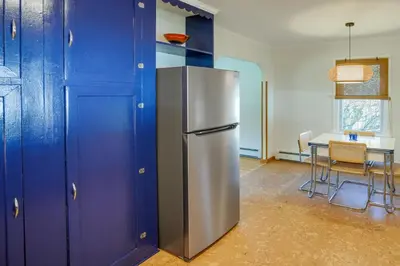 a stainless steel refrigerator in a kitchen with a table at Windham Home Near Mountain Biking and Hiking Trails! in Windham