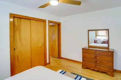 a bedroom with a dresser and a mirror on a dresser at Windham Home Near Mountain Biking and Hiking Trails! in Windham