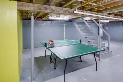 a ping pong table in a room with a staircase at Windham Home Near Mountain Biking and Hiking Trails! in Windham