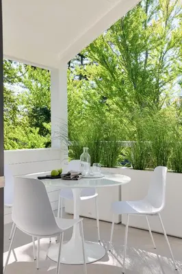 a white dining room with a white table and chairs at 9 Academy in Salisbury