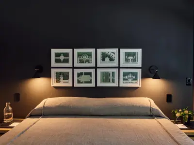 a bedroom with four pictures hanging on the wall at 9 Academy in Salisbury
