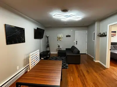 a living room with a couch and a table at Downtown Albany 2 Bedroom + Workstation @ The Mark in Albany