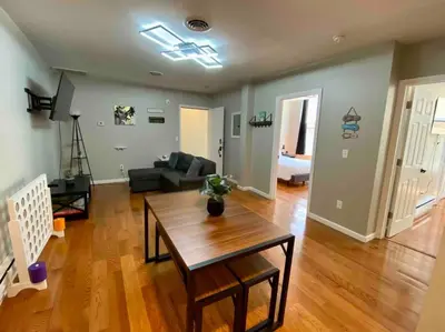 a living room with a table and a couch at Downtown Albany 2 Bedroom + Workstation @ The Mark in Albany