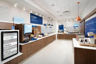a store with wooden counters and a counter top at Holiday Inn Express & Suites Bronx - Zoo Area by IHG in Bronx